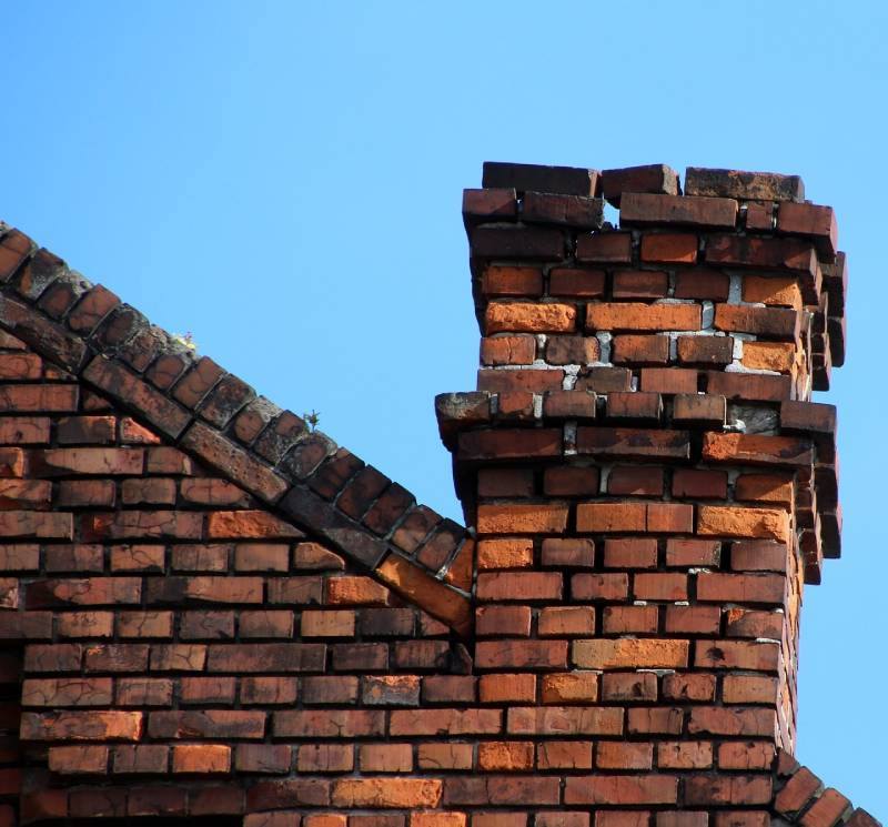 Signs Your Bel Air Home Needs a Chimney Inspection Damaged chimney on an Bel Air home showing cracks and missing mortar
